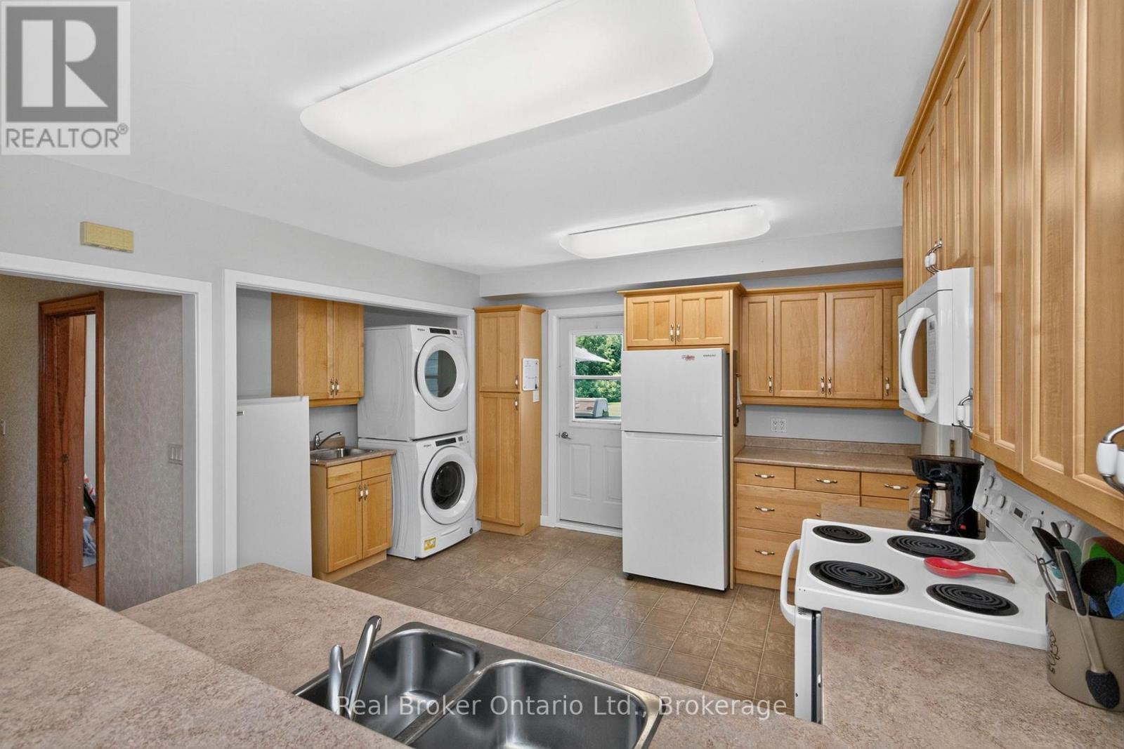 Kitchen with Laundry - 150 Lafontaine Road E, Tiny, ON - Indoor Photo Showing Kitchen With Double Sink