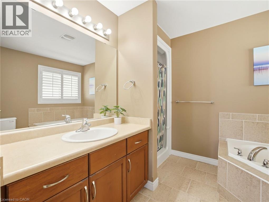 Vanity with integrated sink and chrome faucet, set against warm-toned walls - 98 Willow Lane, Grimsby, ON - Indoor Photo Showing Bathroom