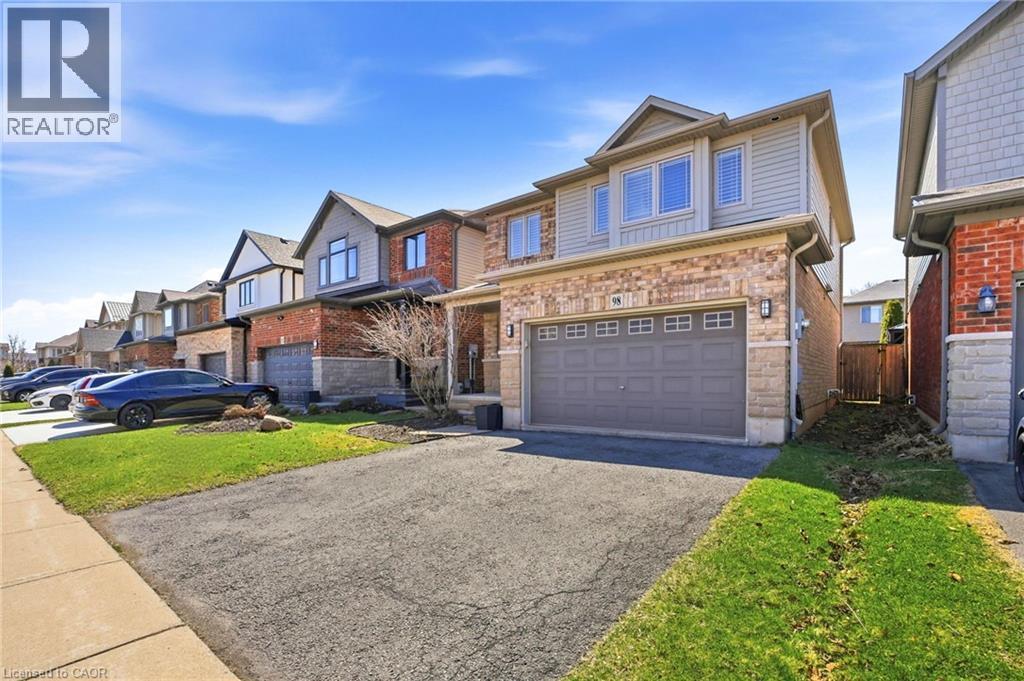 Two-story residence featuring a combination of brick and siding exterior, an attached garage with a dual-width door, and an asphalt driveway - 98 Willow Lane, Grimsby, ON - Outdoor With Facade