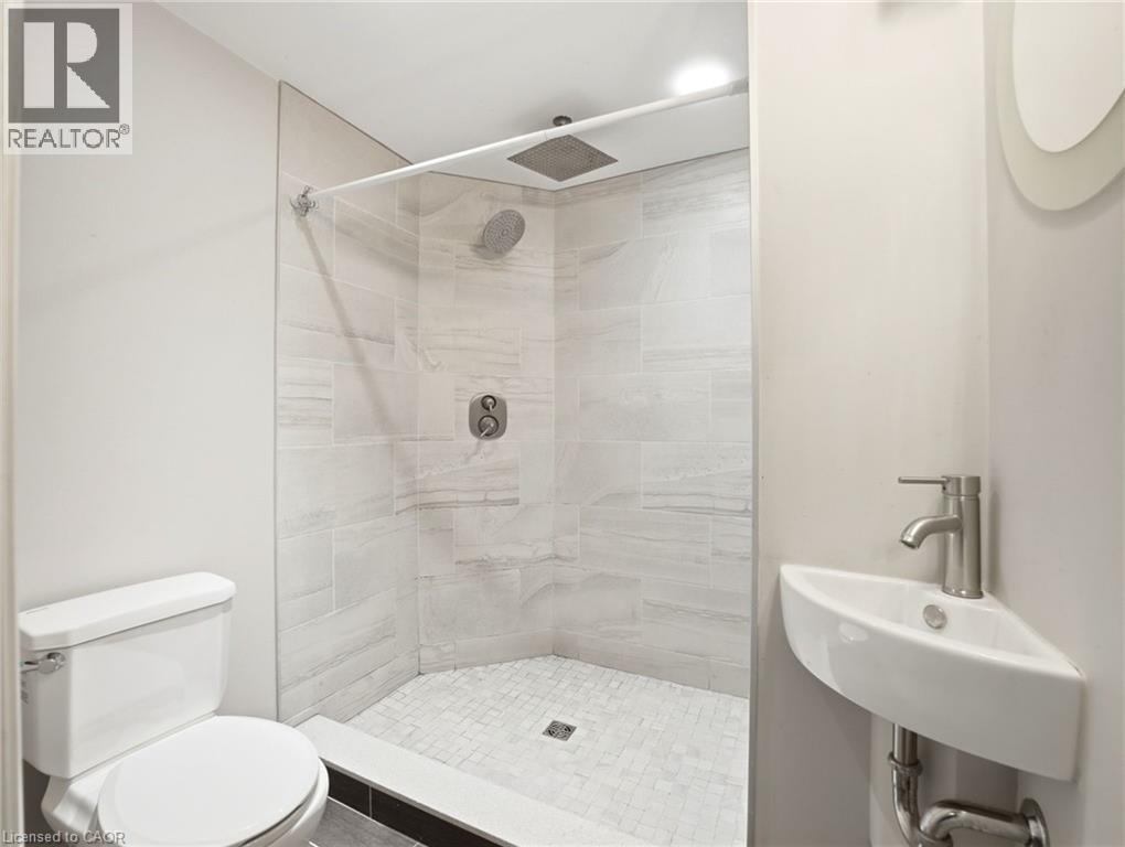 Walk-in shower with full-height tile surround and rain shower head - 98 Willow Lane, Grimsby, ON - Indoor Photo Showing Bathroom