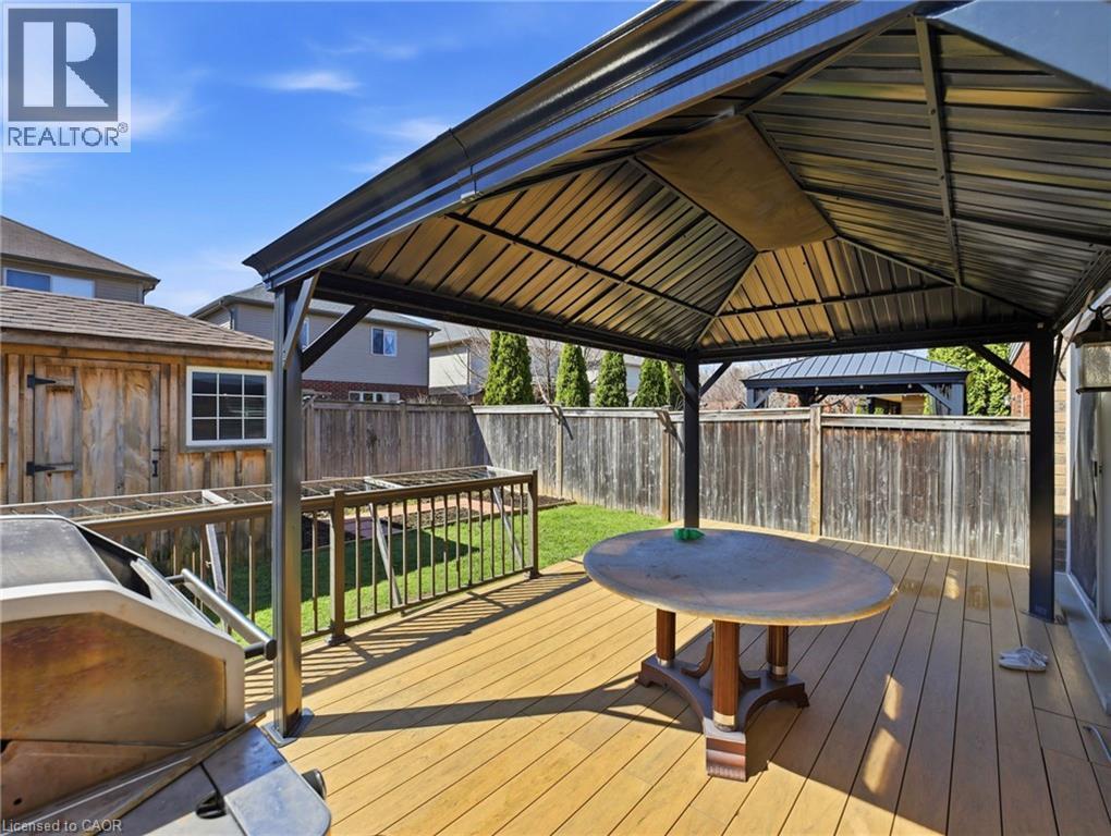 Expansive wood-finish deck featuring a built-in gazebo with a metal roof and a privacy fence surround - 98 Willow Lane, Grimsby, ON - Outdoor With Deck Patio Veranda With Exterior