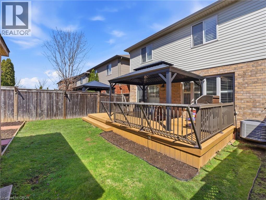 Backyard featuring a multi-level wood-finish deck with dark-toned railings - 98 Willow Lane, Grimsby, ON - Outdoor