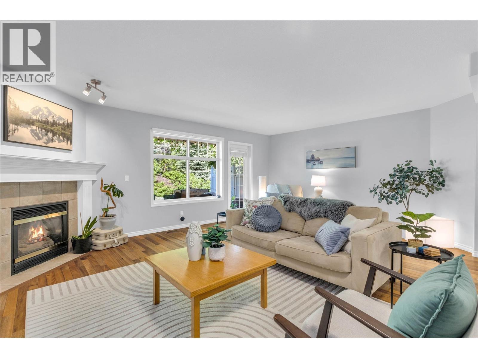Welcome to #104 with its Bright and cozy main living area - 3825 Glen Canyon Drive Unit# 104, West Kelowna, BC - Indoor Photo Showing Living Room With Fireplace