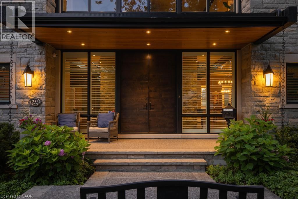 Stone facade with exterior sconce lighting, wood soffit, and recessed lighting - 253 Rossmore Boulevard, Burlington, ON - Outdoor