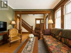 Original hardwood floors, gorgeous wood trrim, a classic staircase with wood balusters, wood-framed windows, and elegant crown molding add plenty of character throughout. - 