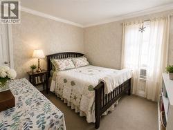 Textured wall covering paired with elegant crown molding adds warmth and character to the space. - 