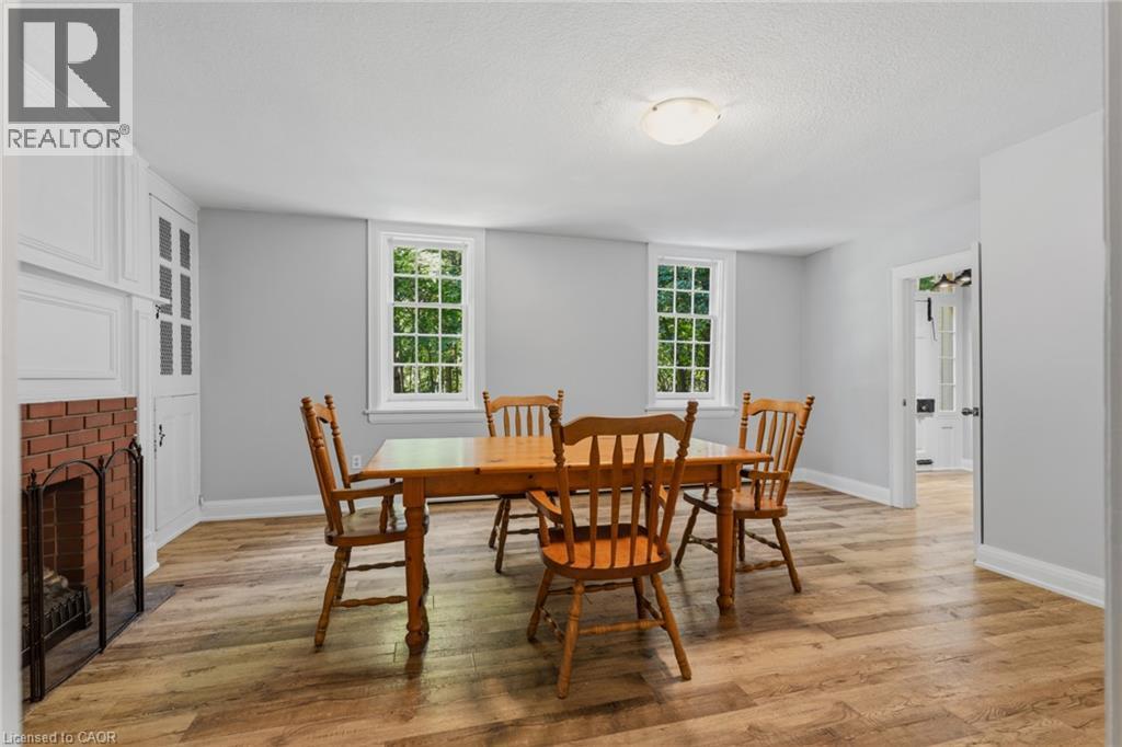 Dining area featuring wood-finish flooring and light gray walls - 41 Mill Street, Mississauga, ON - Indoor Photo Showing Dining Room With Fireplace