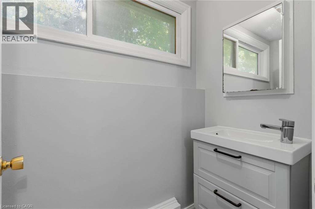 Vanity with integrated sink, chrome faucet, and black hardware - 41 Mill Street, Mississauga, ON - Indoor