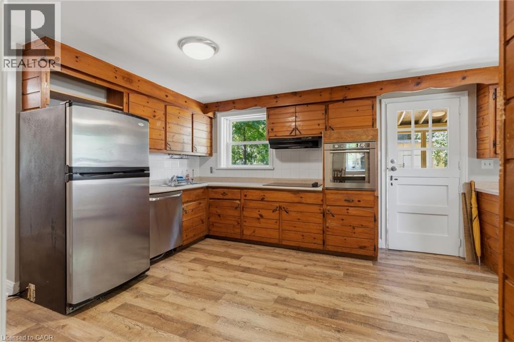 Kitchen featuring wood-finish flooring and extensive wood cabinetry - 41 Mill Street, Mississauga, ON - Indoor Photo Showing Kitchen