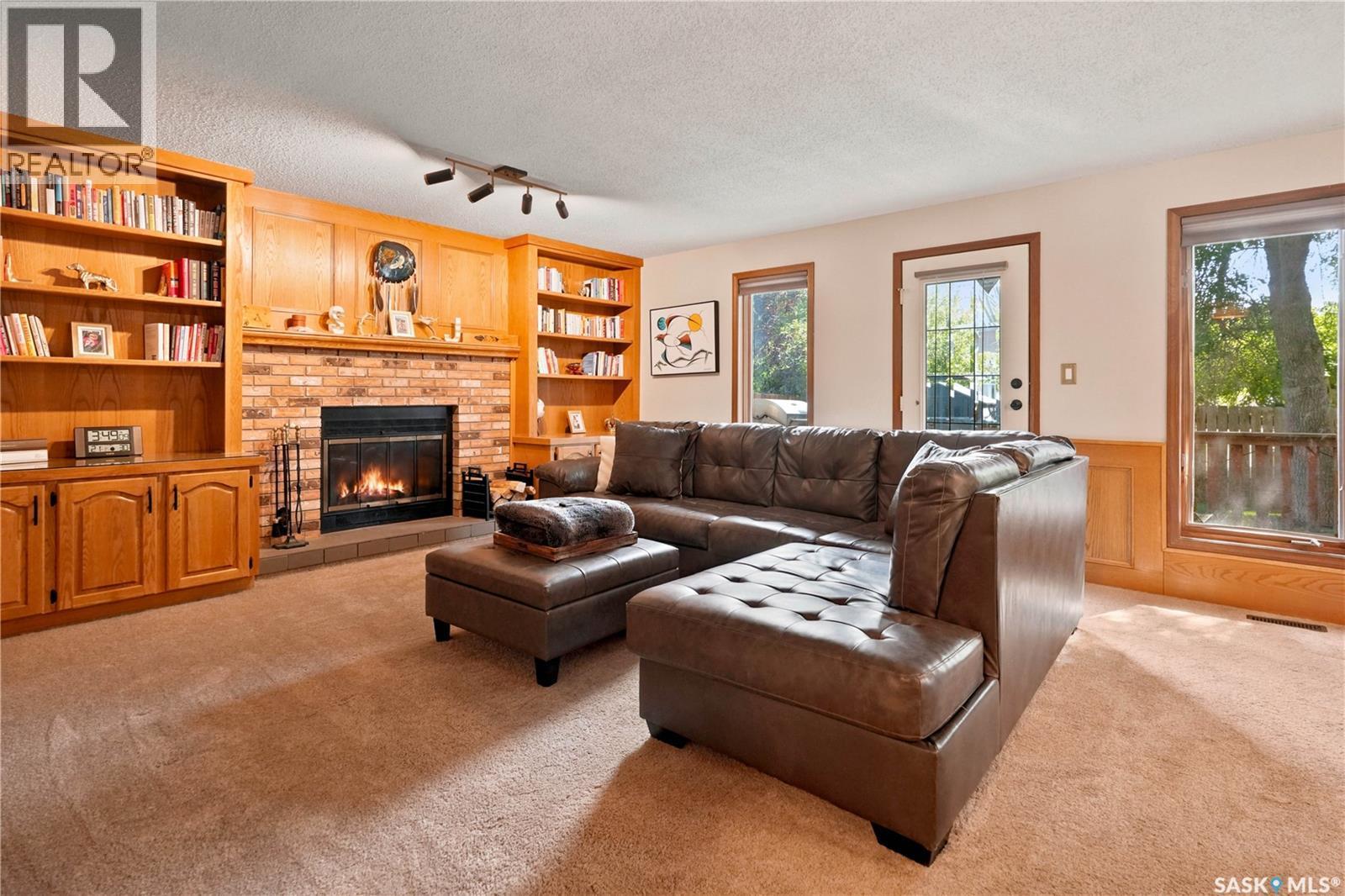 2734 Poplar Place E, Regina, SK - Indoor Photo Showing Living Room With Fireplace