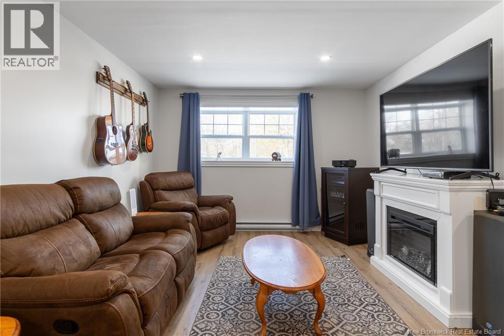 50 Walker Crescent, Hampton, NB - Indoor Photo Showing Living Room With Fireplace