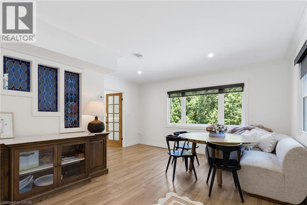 Bright, open living space featuring hardwood flooring, recessed lighting, and large windows with abundant natural light - 21 Kerman Avenue, Grimsby, ON