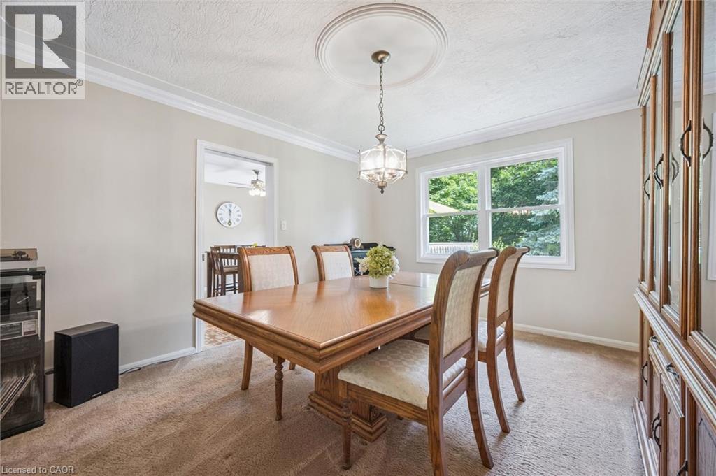 Crown molding and a decorative ceiling medallion complement the overhead light fixture - 119 Sandy Ridge Place, Waterloo, ON - Indoor Photo Showing Dining Room