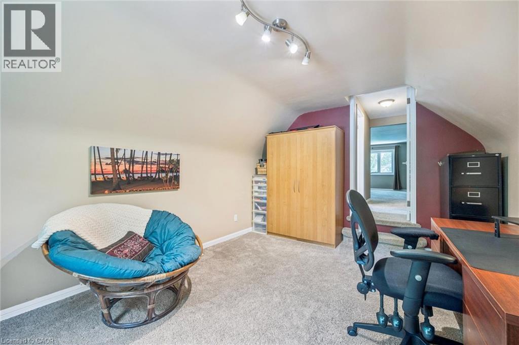 Carpeted room with a vaulted ceiling, track lighting, and a neutral wall color - 119 Sandy Ridge Place, Waterloo, ON - Indoor Photo Showing Other Room