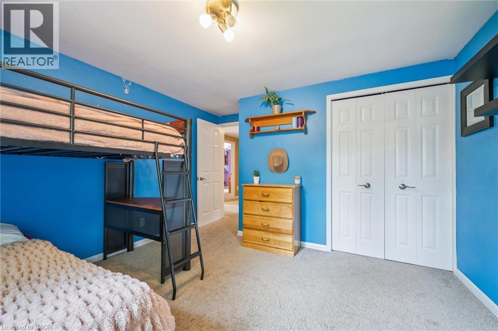Carpeted flooring, bi-fold closet doors, and overhead lighting - 119 Sandy Ridge Place, Waterloo, ON - Indoor Photo Showing Bedroom
