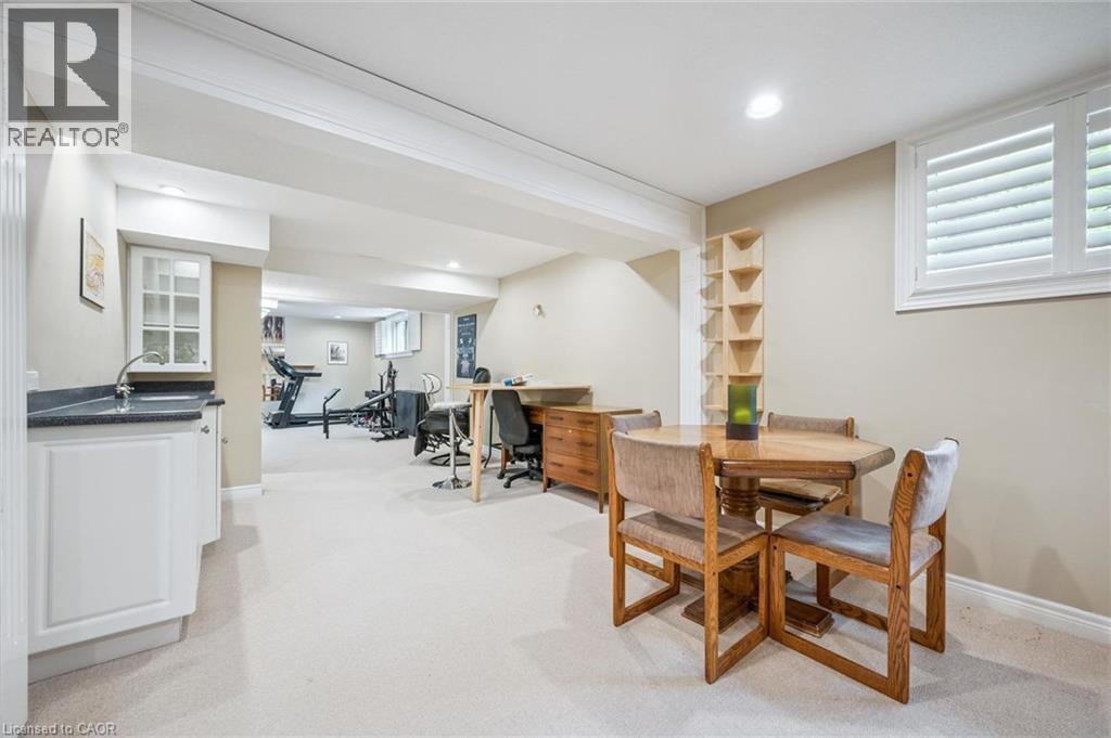 Recessed lighting, light-colored carpeting, white window shutters, built-in shelving, and a wet bar with white cabinetry - 119 Sandy Ridge Place, Waterloo, ON - Indoor