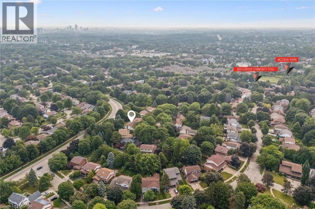 Aerial perspective of a verdant residential area featuring mature tree cover and varied architectural styles - 119 Sandy Ridge Place, Waterloo, ON - Outdoor With View