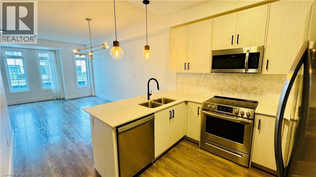 Integrated kitchen with stainless steel appliances, dual-basin sink, and hexagon tile backsplash - 1159 Lloyd Landing, Milton, ON - Indoor Photo Showing Kitchen With Double Sink