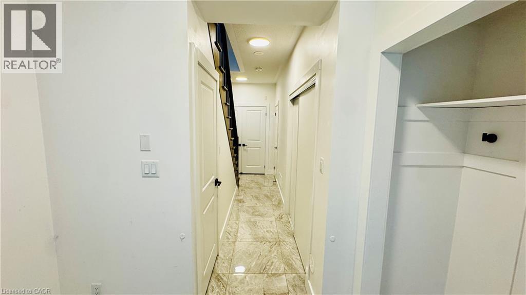 Hallway featuring recessed lighting, panel doors, a built-in closet with shelving, and tile flooring - 1159 Lloyd Landing, Milton, ON - Indoor Photo Showing Other Room