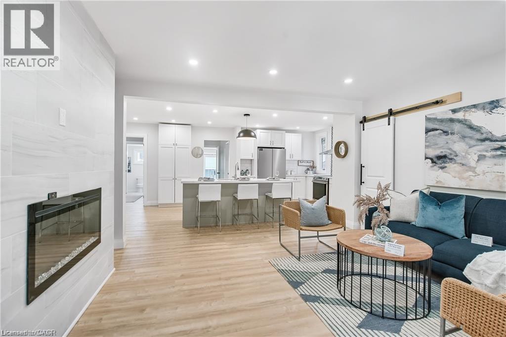 Open-concept living space featuring wood-finish flooring and recessed lighting - 10 Comet Avenue Unit# #1 (Main), Hamilton, ON - Indoor Photo Showing Living Room With Fireplace