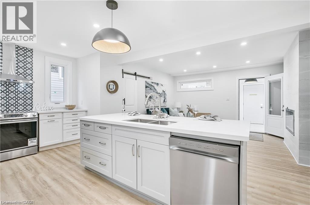 Kitchen with a large central island featuring a double basin sink and integrated stainless steel dishwasher - 10 Comet Avenue Unit# #1 (Main), Hamilton, ON - Indoor Photo Showing Kitchen With Double Sink With Upgraded Kitchen