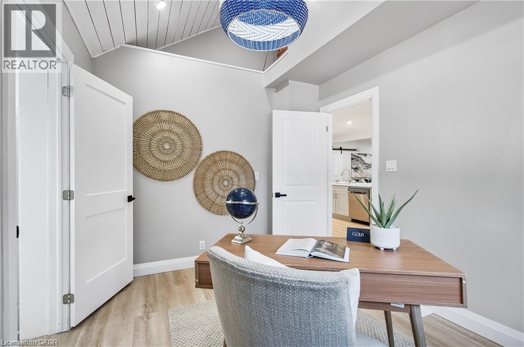 Room featuring light wood-finish flooring, white doors with matte black hardware, and a vaulted ceiling with white shiplap detailing - 10 Comet Avenue Unit# #1 (Main), Hamilton, ON - Indoor Photo Showing Office