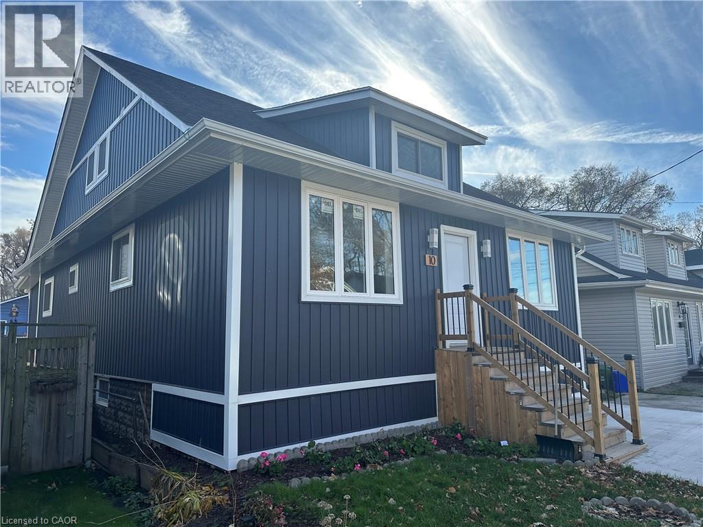 Contemporary exterior with dark vertical siding, white trim, and a prominent peaked roofline - 10 Comet Avenue Unit# #1 (Main), Hamilton, ON - Outdoor