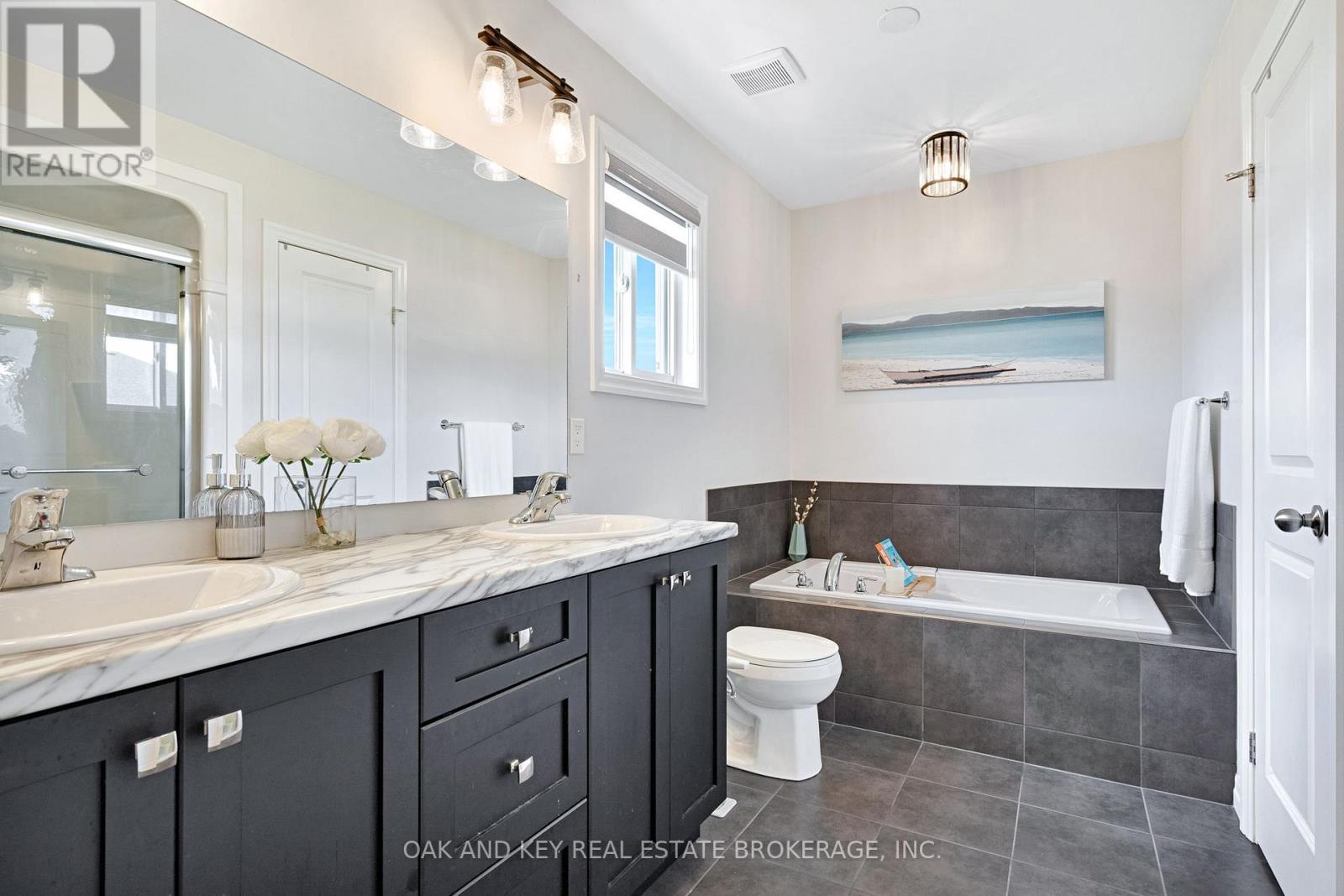 Primary ensuite - 2 sinks, soaker tub, and shower - 48 Ambrosia Path, St. Thomas, ON - Indoor Photo Showing Bathroom