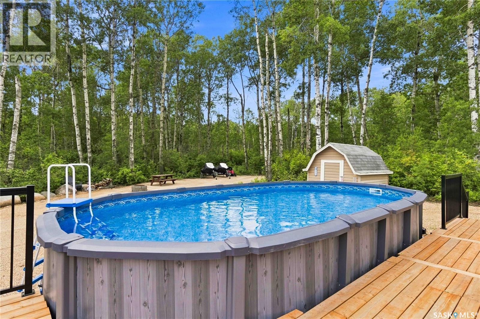501 Coner Heights, Barrier Lake, SK - Outdoor With Above Ground Pool With Backyard