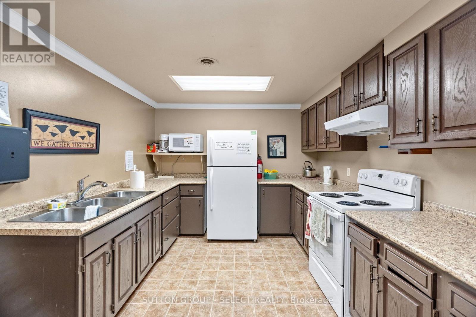 COMMUNITY CLUBHOUSE - 14 Devon Drive, South Huron (Exeter), ON - Indoor Photo Showing Kitchen With Double Sink