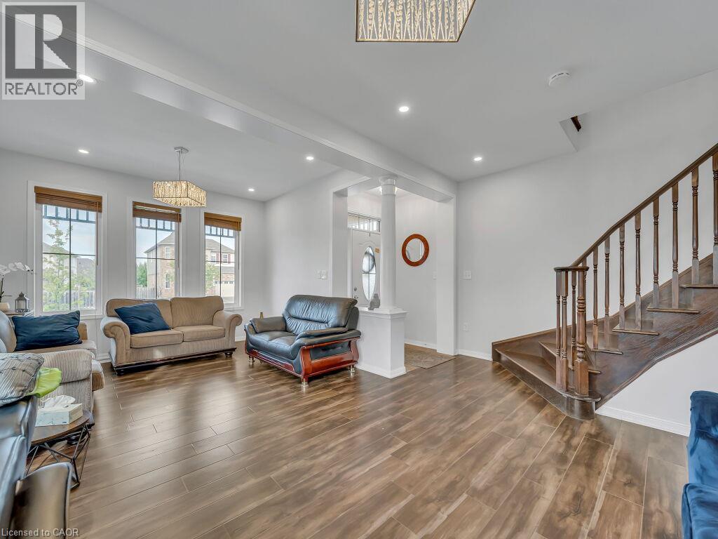 Wood-finish flooring throughout, recessed lighting, and large windows with blinds - 227 Baldwin Drive Unit# Main, Cambridge, ON - Indoor Photo Showing Living Room