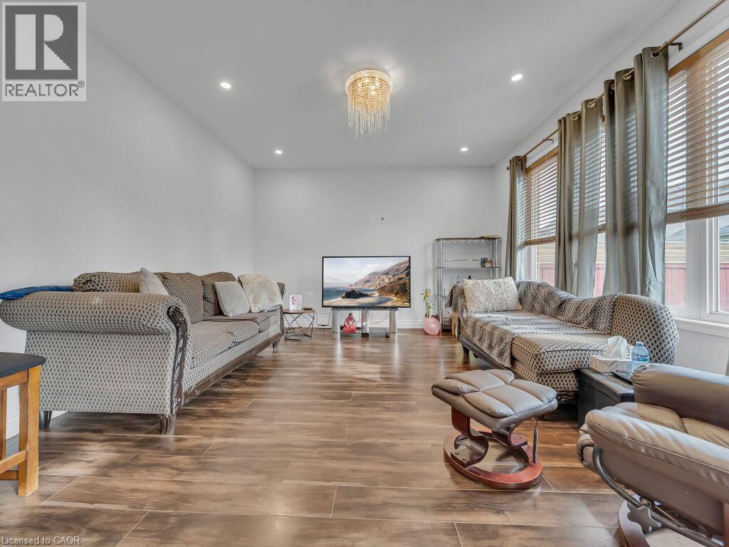 Recessed lighting and a decorative chandelier illuminate the space - 227 Baldwin Drive Unit# Main, Cambridge, ON - Indoor Photo Showing Living Room