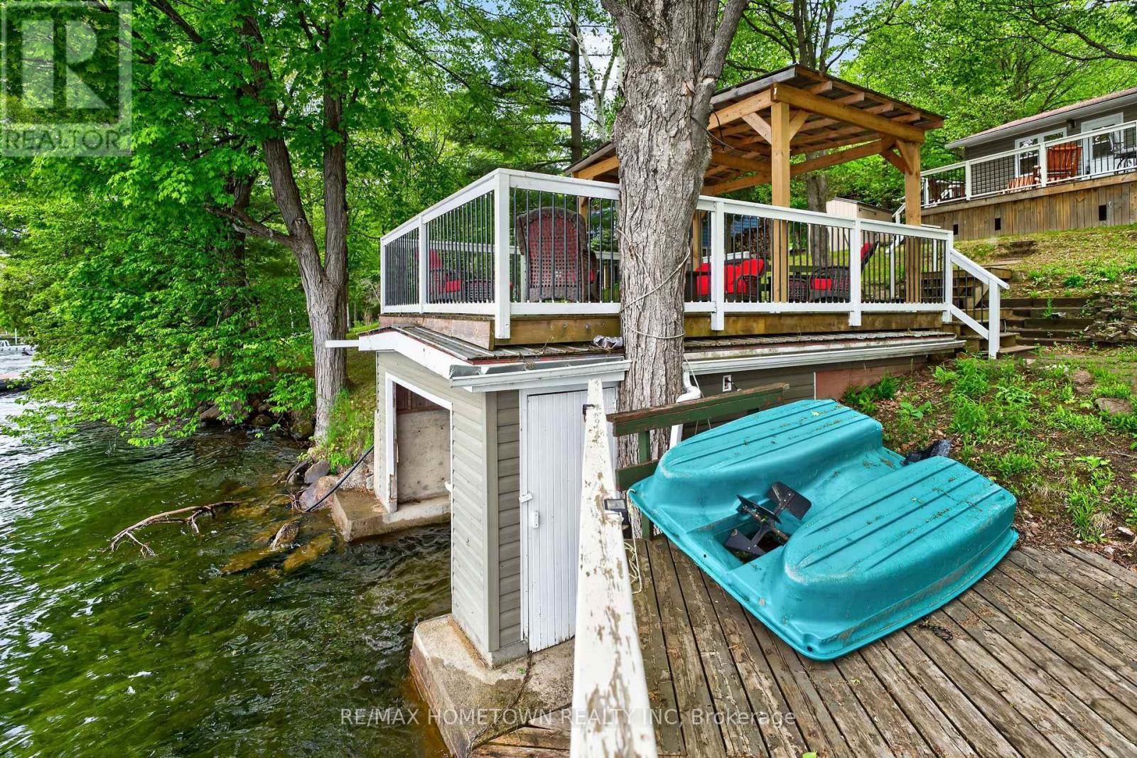 Side view of Boathouse and upper covered patio - 66 Scott Lane, Rideau Lakes, ON - Outdoor With Deck Patio Veranda
