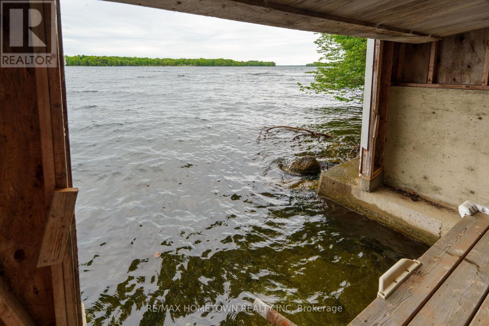 Looking out of boathouse with concrete foundation - 66 Scott Lane, Rideau Lakes, ON - Outdoor With Body Of Water With View