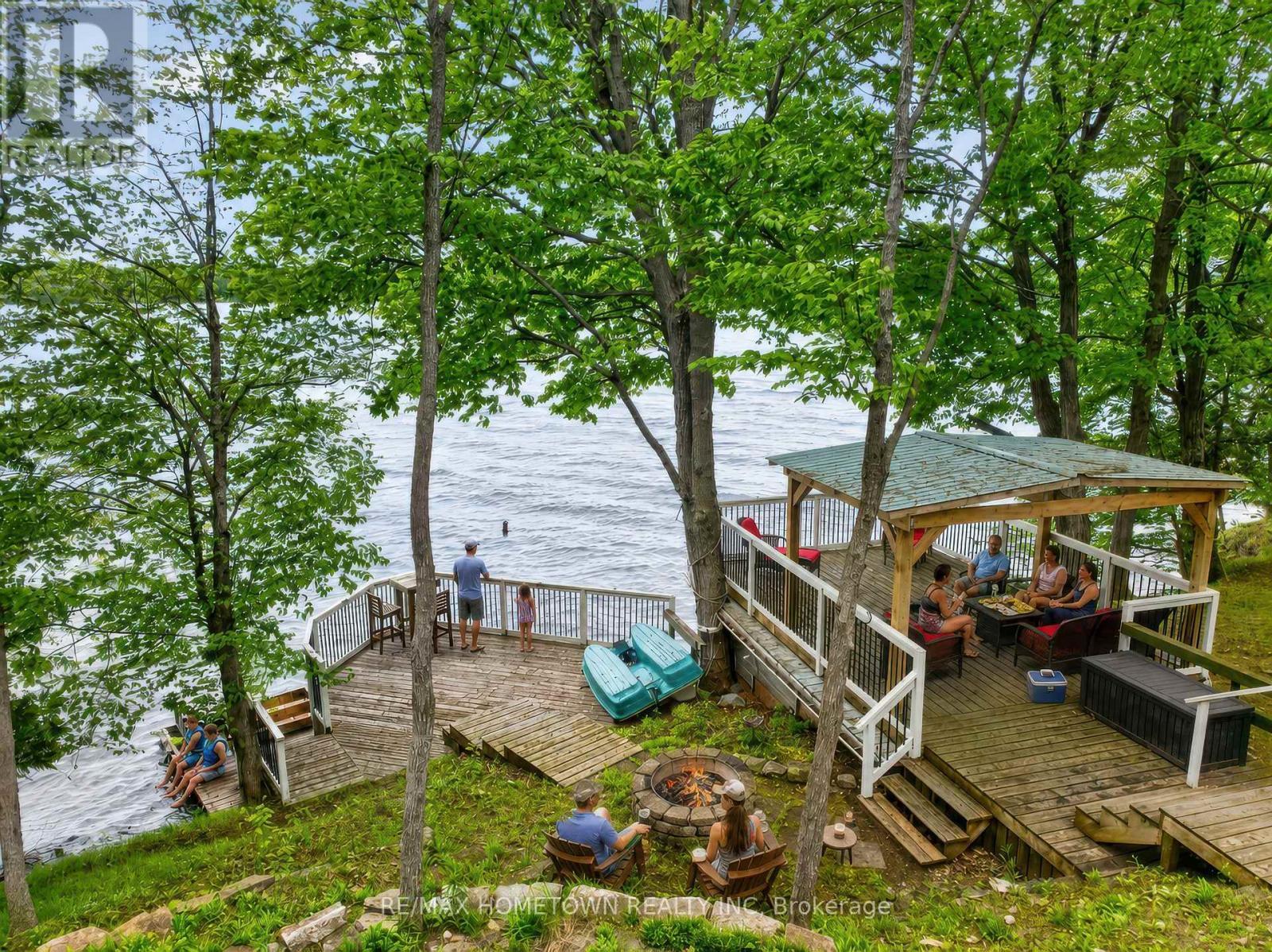 Lifestyle shot, entertain on all levels - 66 Scott Lane, Rideau Lakes, ON - Outdoor With Body Of Water With Deck Patio Veranda