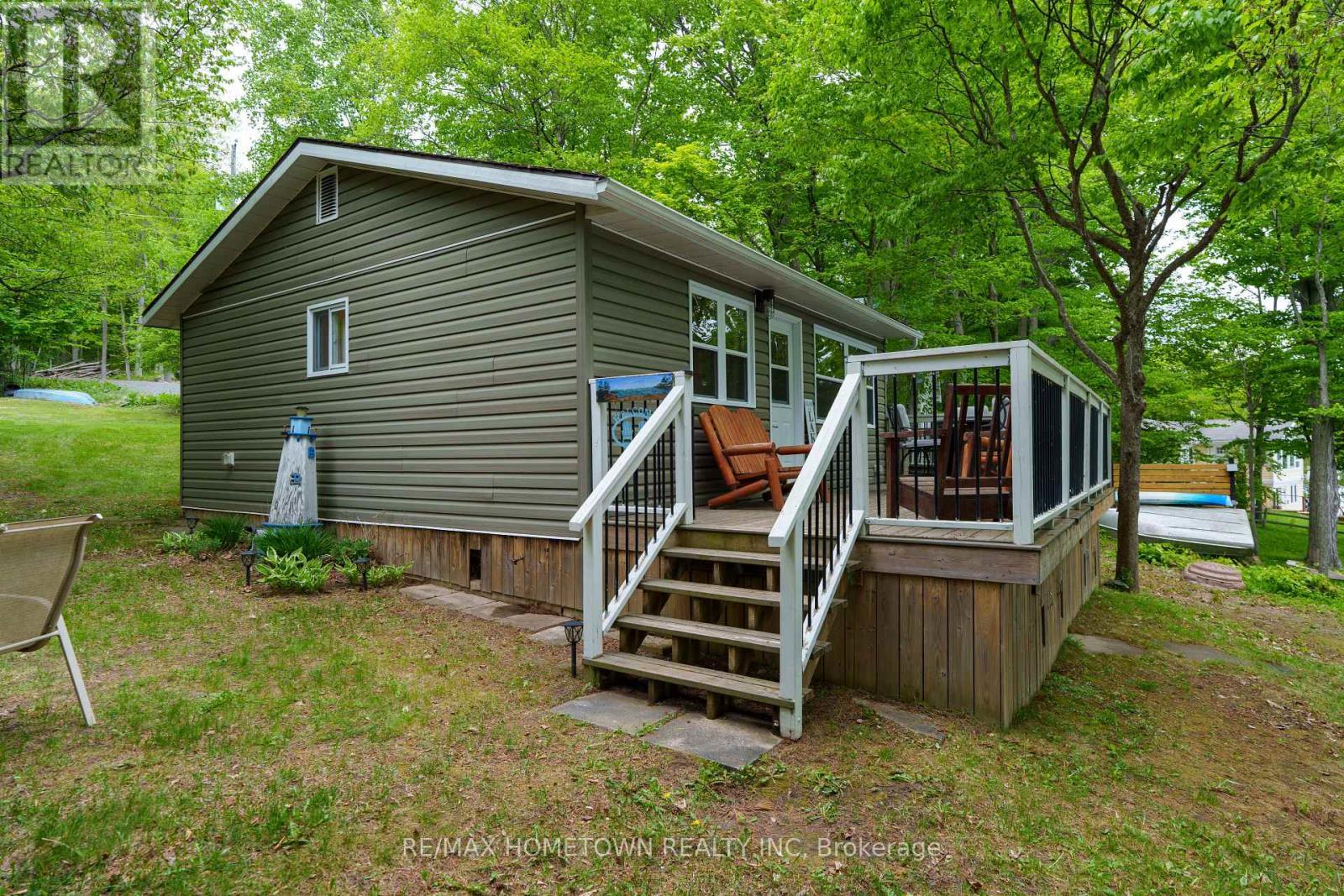 Deck leading to front entry of the cottage. - 66 Scott Lane, Rideau Lakes, ON - Outdoor With Exterior