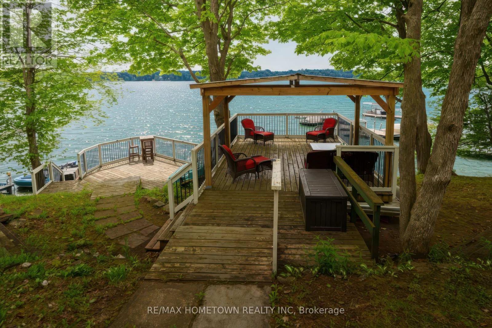 2 tier decks and covered boathouse patio - 66 Scott Lane, Rideau Lakes, ON - Outdoor With Body Of Water With Deck Patio Veranda