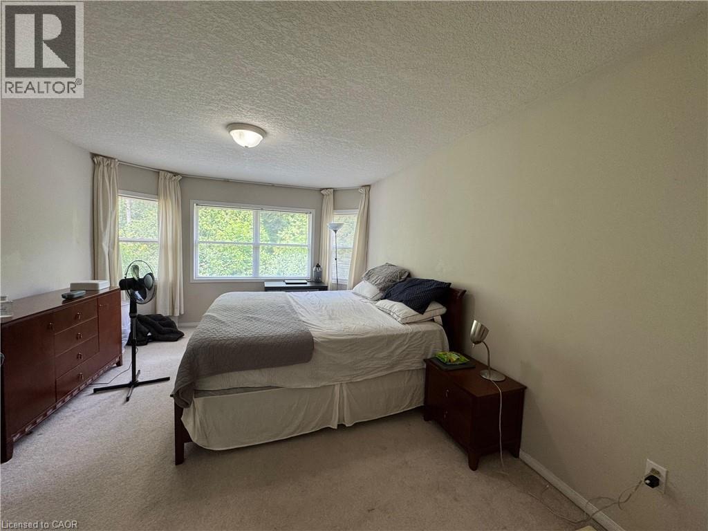 Neutral wall tones with carpeted flooring - 720 Brookmill Place, Waterloo, ON - Indoor Photo Showing Bedroom