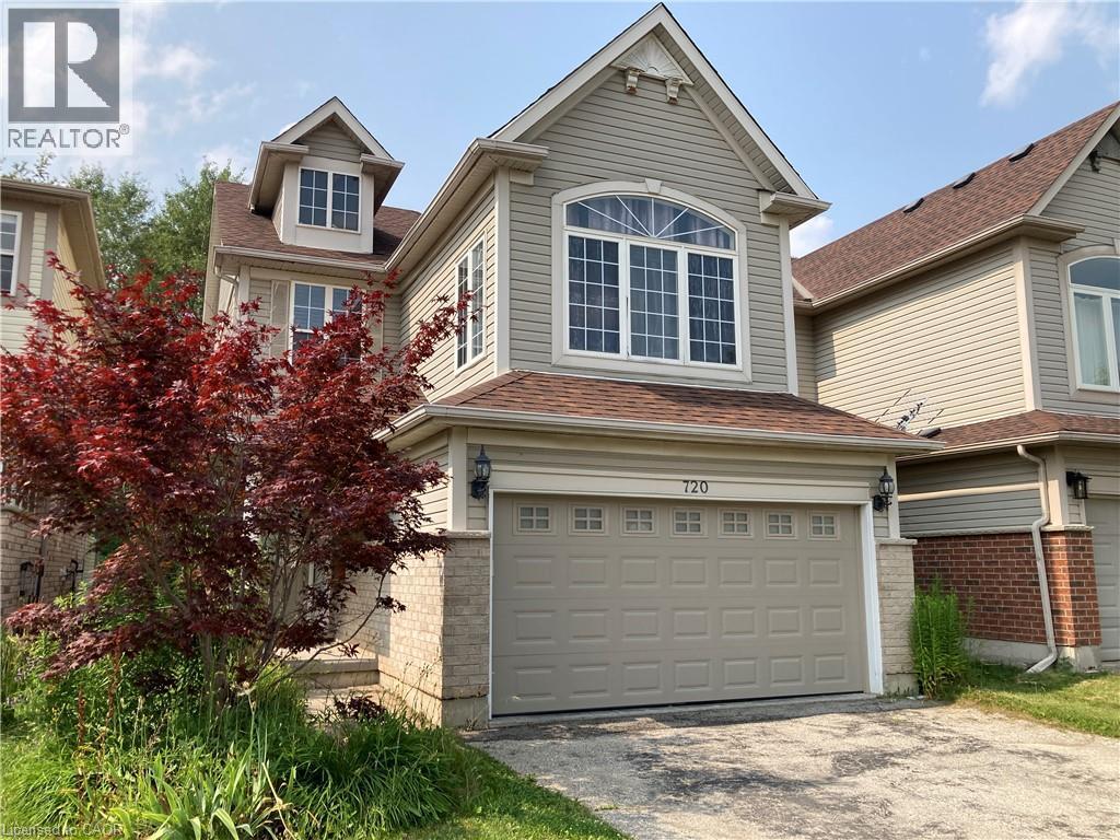Two-story residence featuring light-colored siding, brick accents, and a brown shingle roof - 720 Brookmill Place, Waterloo, ON - Outdoor