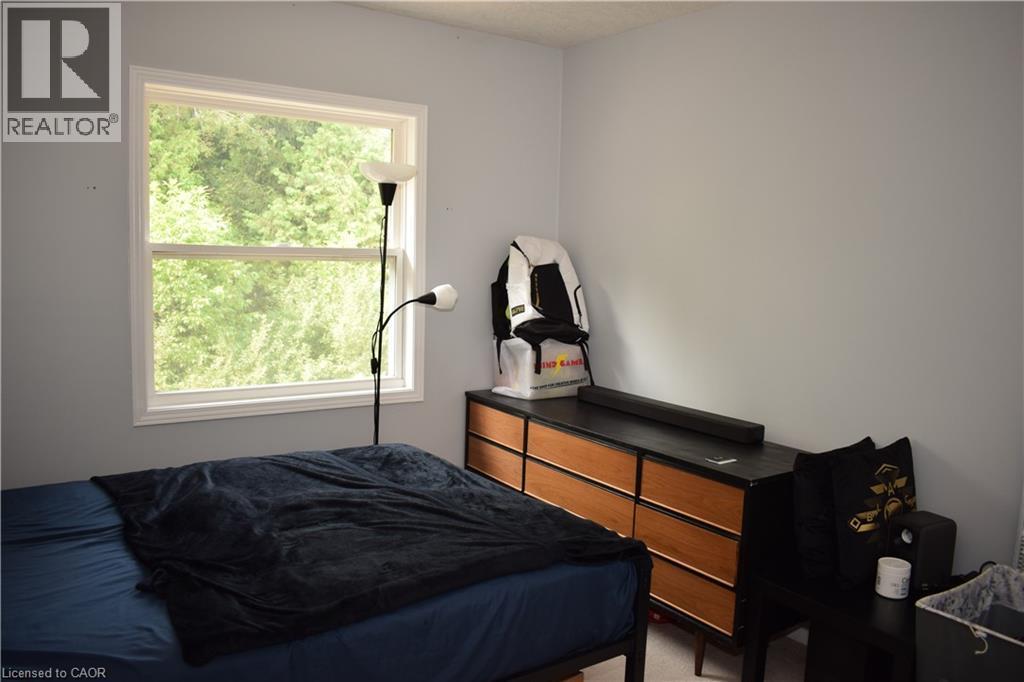 White-trimmed window, light-colored wall paint, and ceiling - 720 Brookmill Place, Waterloo, ON - Indoor Photo Showing Bedroom