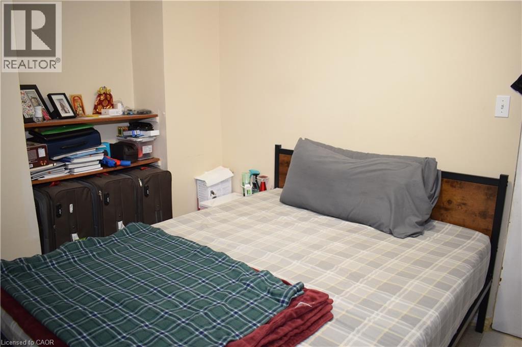 Built-in shelving with wood-finish shelves - 720 Brookmill Place, Waterloo, ON - Indoor Photo Showing Bedroom