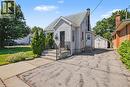 Gabled roofline, siding exterior, paved driveway, detached garage, and mature trees - 16 Mercer Road, Cambridge, ON  - Outdoor 