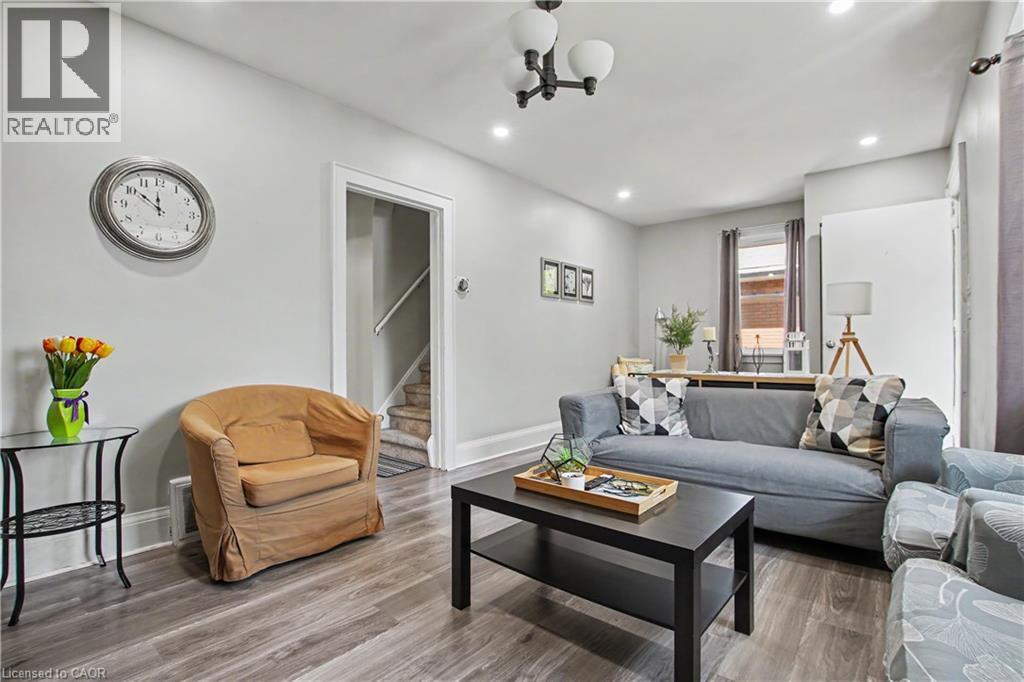 Wood-finish flooring throughout, recessed ceiling lighting, and a contemporary ceiling light fixture - 16 Mercer Road, Cambridge, ON - Indoor Photo Showing Living Room