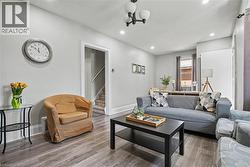 Wood-finish flooring throughout, recessed ceiling lighting, and a contemporary ceiling light fixture -
