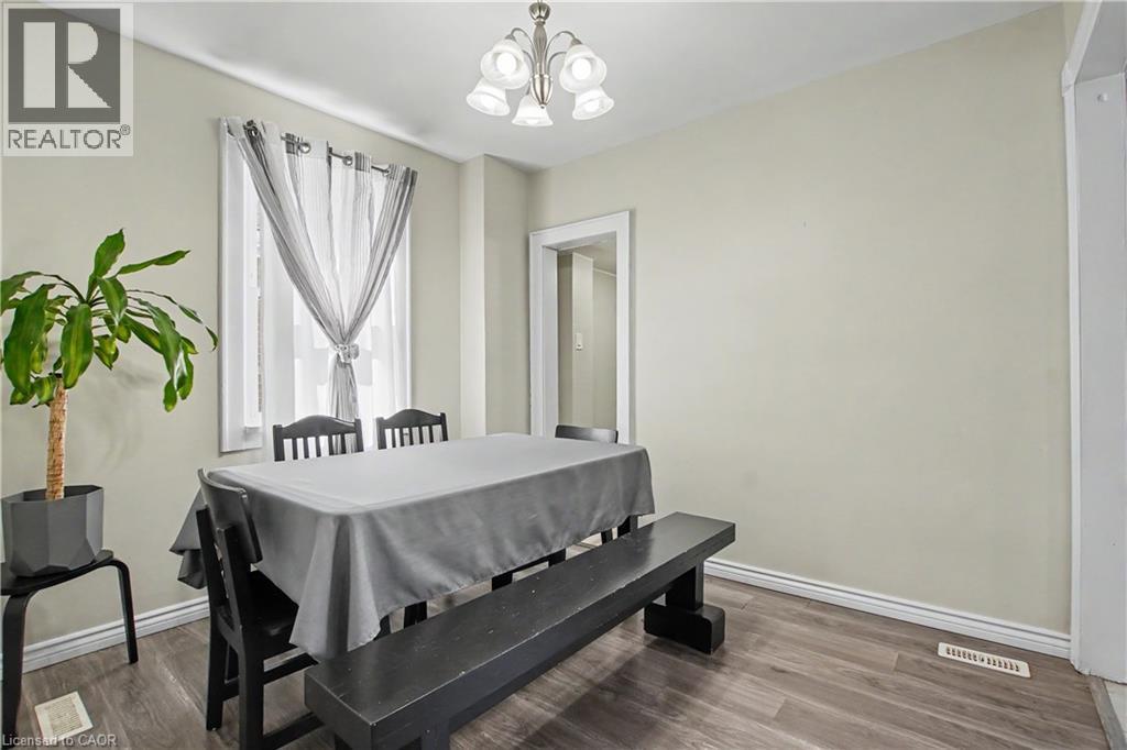 Recessed window, wood-finish flooring, brushed nickel chandelier, white trim, light neutral wall paint - 16 Mercer Road, Cambridge, ON - Indoor