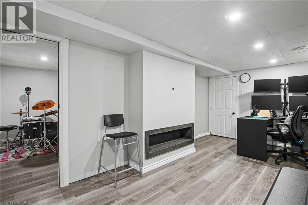 Recessed lighting, wood-finish flooring, white paneled door, and a built-in media niche - 16 Mercer Road, Cambridge, ON - Indoor Photo Showing Office