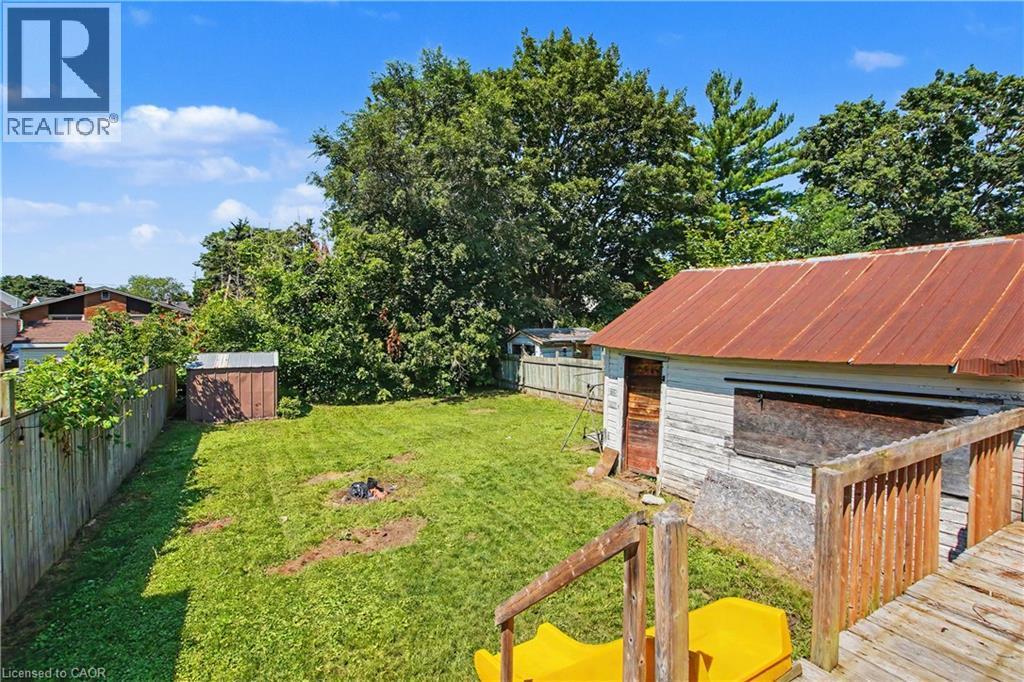 Expansive backyard featuring a manicured lawn, established perimeter fencing, and a detached storage shed - 16 Mercer Road, Cambridge, ON - Outdoor