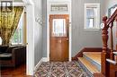 Wood-finish entry door with decorative transom window and patterned floor tiles - 128 Hess Street N, Hamilton, ON  - Indoor Photo Showing Other Room 