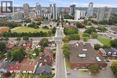 Urban skyline backdrop with a mixed-use district, residential street with varied architectural styles. - 128 Hess Street N, Hamilton, ON - Outdoor With View