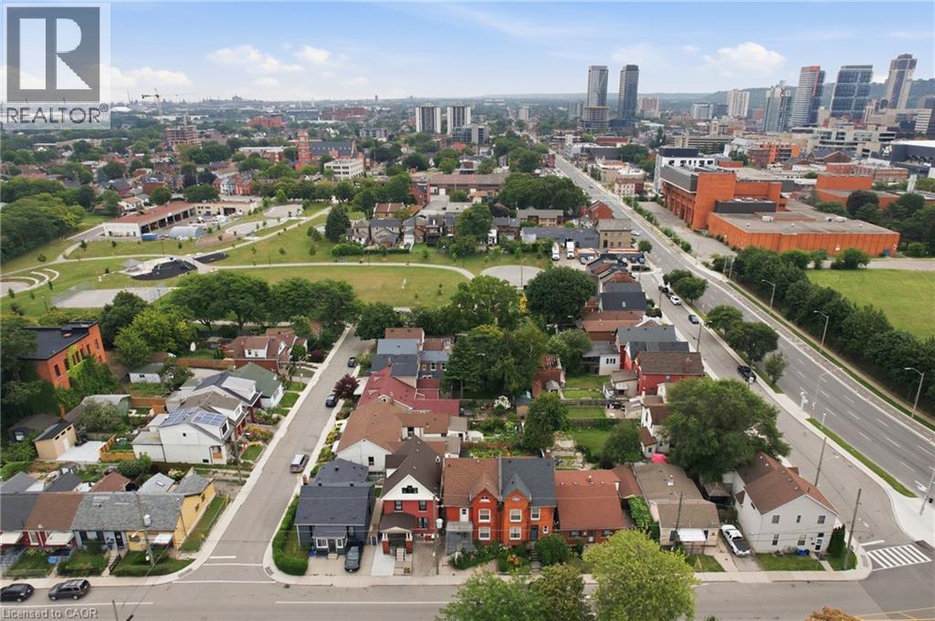 Aerial perspective highlighting residential properties, public green spaces, and urban infrastructure - 128 Hess Street N, Hamilton, ON - Outdoor With View